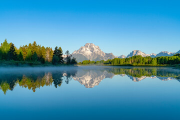 Wall Mural - landscape of snow mountain reflecting in the lake in the morning