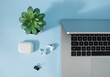 © Ljuba3dArt - Creative office environment and working atmosphere for working at home. Coffee, laptop, phone and headphones on pastel blue desk background...