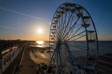 A Ferris Wheel And Sunrise At A British Seaside Resort