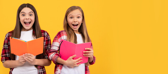 Canvas Print - School girls friends. amazed kids in casual checkered shirt having fun reding books, amazement. Portrait of schoolgirl student, studio banner header. School child face, copyspace.