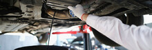 Mechanic Man On Car Maintenance Service Change Oil Under Transport