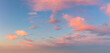 Pastel light pink clouds in the blue sky during dawn sunset, sky background