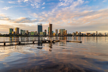 Wall Mural - Sunset cityscape. Perth, Western Australia. July 2022. View of Perth from South Perth, with jetty in foreground. 