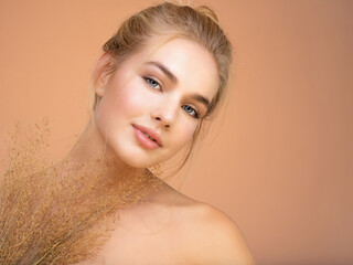 Poster - Portrait of young beautiful woman with a healthy  skin of face.  Attractive girl with a bunch spring field flowers