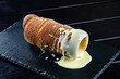 trdelnik with condensed milk filled with buttercream on a black serving tray, free space for the text