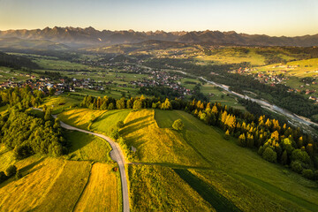 Wall Mural - Farm landscape on rolling hills in Tatras mountains at summer sunrise