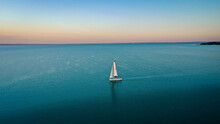 Aerial View Of Sailboat At Sunset