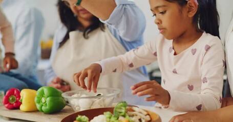 Poster - Happy family cooking dinner together in the home kitchen at home. Young girl helping her grandmother prepare a healthy meal with vegetables. Independent daughter making food with an older woman