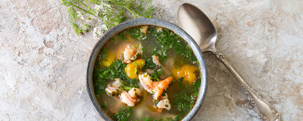 a bowl of shrimp soup on a light table