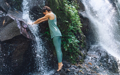 European girl doing yoga and walking in nature.