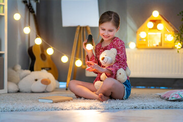 Wall Mural - Happy little girl playing with shadows in children's room