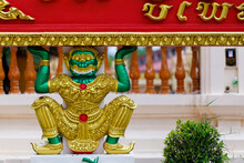 A Giant Green Statue, Dressed In Gold, Is Sitting Carrying A Sign. It Is Located At Wat Burapha Phiram, Muang District, Roi Et Province, Thailand.
