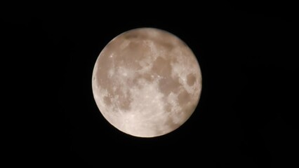 Wall Mural - Full moon close-up dark clouds fly by. Moon in the black sky. Real shooting