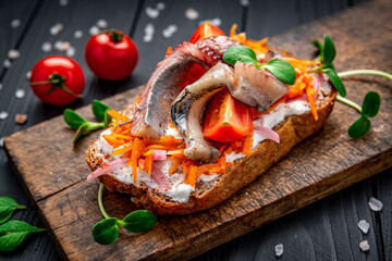 Wall Mural - Sandwich with slices of pickled Atlantic herring fillet, pickled onions and carrots