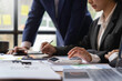 © crizzystudio - team of financiers are analyzing the company's earnings at meetings, intercompany business meetings.