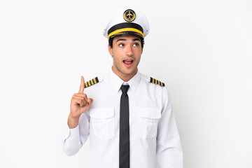 Wall Mural - Airplane pilot over isolated white background intending to realizes the solution while lifting a finger up