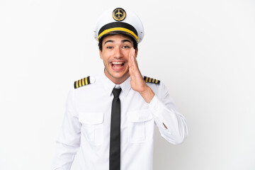 Wall Mural - Airplane pilot over isolated white background shouting with mouth wide open