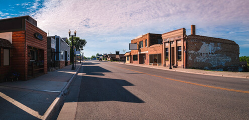 Wall Mural - Old western cityscape and skyline at cloudy sunset. Quiet streets and rustic buildings in the historic downtown of Ortonville, Minnesota, USA.