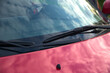 Car windshield wipers on the windshield of the car. Body elements. Red car body.