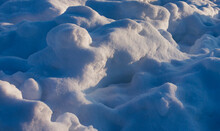 Brightly Lit Wavy Texture Snow With Deep Blue Shadows In The Evening Sun