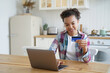 © VK Studio - Young biracial girl ecommerce client using banking credit card to pay online on laptop at home