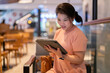 asian freelace woman digitaal nomad remotely working in cafe hand searching ideas trend in tablet via social browser,casual relax asia woman working in cafe restaurant concentrate and focus feeling