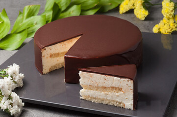 Wall Mural - Delicate souffle combined with fragrant almond sponge cake, decorated with natural chocolate glaze