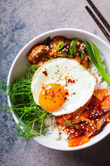 Wall Mural - Bibimbap - meat, rice, kimchi, egg and sprouts in white bowl. Traditional Korean food.