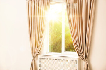  Bright sun shining through window with stylish curtains