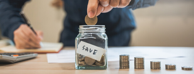 the person putting coin into piggy bank to save money and invest for growth in future.