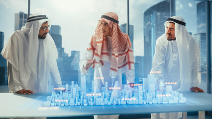 Wall Mural - Group of Arab Real Estate Business Developers in Traditional Clothes Discuss Investing Opportunities Based on Holographic Augmented Reality 3D City Model in Their Modern Office in a Skyscraper.