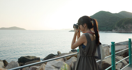 Travel woman take photo of the landscape