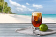 © Pixel-Shot - Glass of tasty Cuba Libre cocktail on table at tropical resort