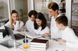 © Rabizo Anatolii - Education. Chemistry teacher helps explain theory in class at chemistry lesson in laboratory. Communication between teacher and students. Preparing homework.