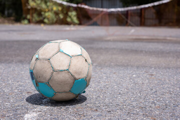 old soccer ball on street floor