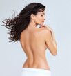 © Mr. Skin/peopleimages.com - Portrait of a beautiful woman showing her smooth and shapely back, isolated on white - copyspace
