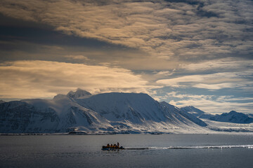 Sticker - 2022-07-16 A SMALL ZODIAC MOTORING IN FRONT OF A SNOW COVERED MOUNTAIN RANGE NEAR SVALBARD NORAY IN THE ARCTIC