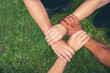 © aFotostock - Top View Four hands Diverse multiethnic Partner team together. Close up Teamwork group of Four multiracial people join hands together. Above view Diversity people hand join partner team trust team