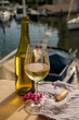 Drinking of cold white wine  with view on yacht harbour of Port Grimaud, summer vacation on French Riviera, France