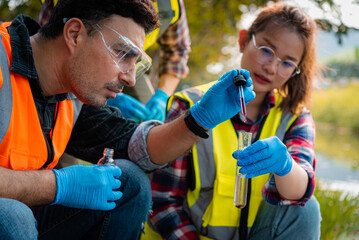 Scientists team collect water samples for analysis and research on water quality, environment with saving earth.