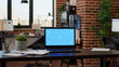 © DC Studio - No people in empty startup office with greenscreen on laptop, chroma key background application on display. Computer with isolated mockup template and blank copyspace screen on desk.