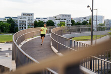 Young Man Running On Elevated Walkway