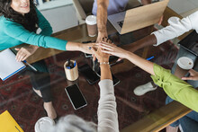 Business Colleagues Stacking Hands Together In Office