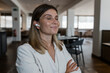 © Westend61 - Smiling businesswoman with eyes closed listening music through wireless in-ear headphones at restaurant