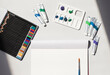 © Westend61 - Studio shot of art and craft equipment including colored pencils, blank drawing paper, oil paint tubes, artists palette and single paintbrush