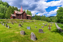 Norway, Viken, Rollag, Cemetery In Front Of Medieval Stave Church In Summer