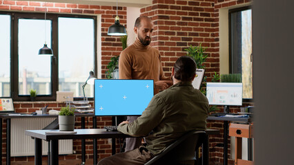 Poster - Company worker looking at greenscreen on computer and business charts, using chroma key display in office. Working with isolated copyspace template and blank mockup background.