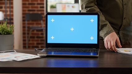 Poster - Laptop with greenscreen background in startup business workplace, empty desk with isolated chroma key and mockup template. Blank copyspace display on wireless computer, web app.