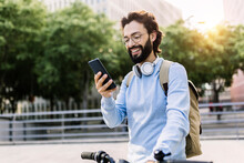 Happy Man With Bicycle Using Mobile Phone