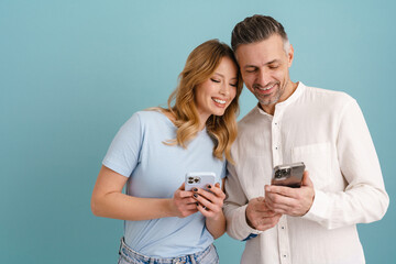 Wall Mural - White happy woman and man smiling while using cellphones